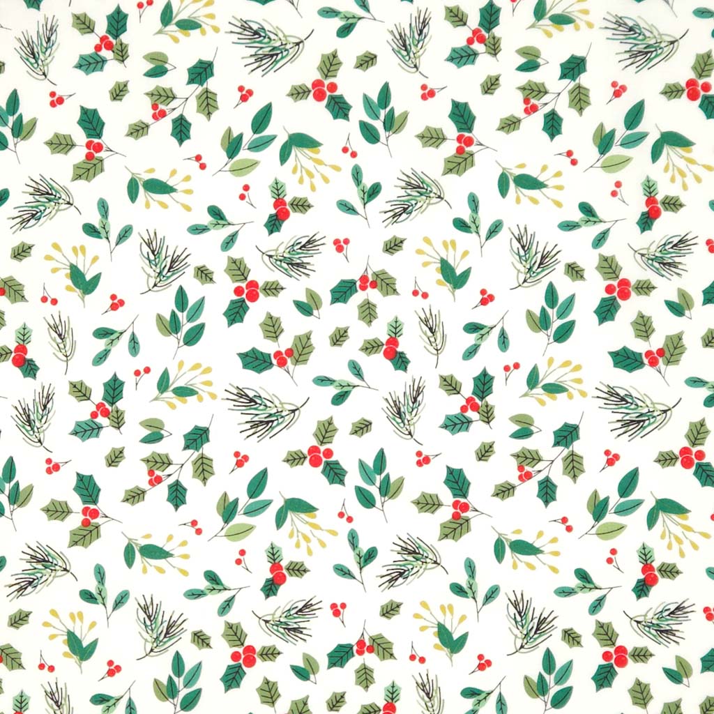 Pattern of Christmas foliage with green leaves, red berries, and pinecones on an ivory cotton fabric