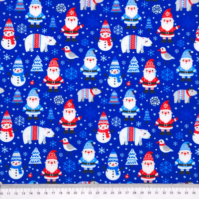 Pattern of Santa Claus, snowmen, and polar bears on a blue polycotton fabric with trees and birds.