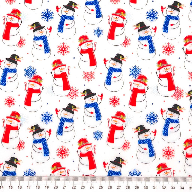 Jolly snowmen printed on a white polycotton fabric with a cm ruler