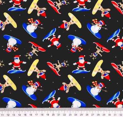 Snowboarding chrismas characters printed on a black polycotton fabric with a cm ruler