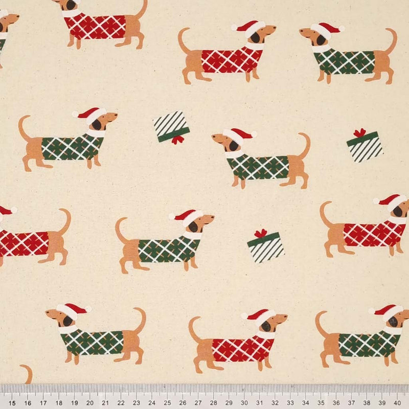 Christmas jumper wearing dachshunds and gifts printed on a natural 100% cotton fabric with a cm ruler