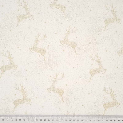 Christmas reindeer design that is made entirely of clustered gold dots and stars to create a frosty, wintery sky scape pattern printed on a cream 100% cotton fabric with a cm ruler