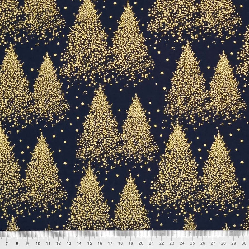 A Christmas tree design that is made entirely of clustered gold dots to create a frosty, wintery forest pattern printed on a navy 100% cotton fabric with a cm ruler