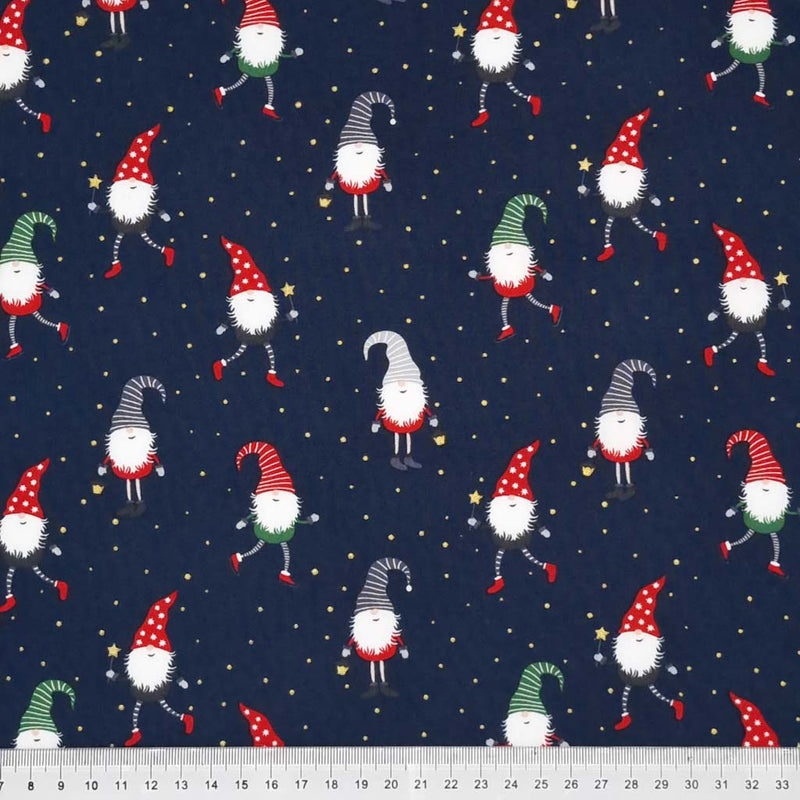 Festive gonks are printed on a navy cotton fabric with a cm ruler