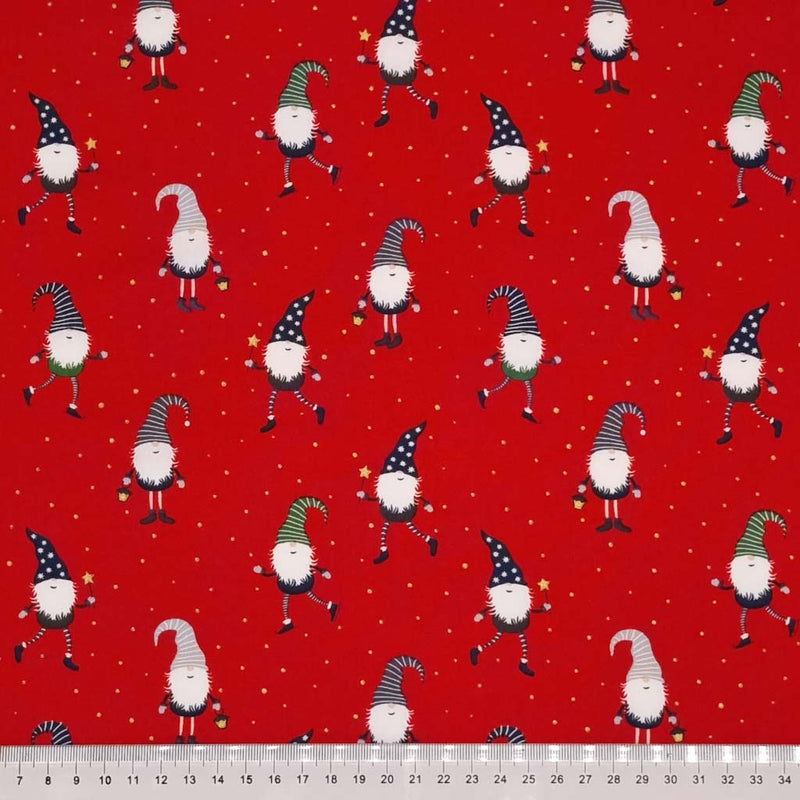 Festive gonks are printed on a red cotton fabric with a cm ruler