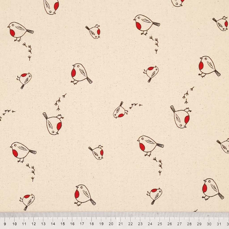 Christmas robins and their footprints on a natural 100% cotton fabric with a cm ruler