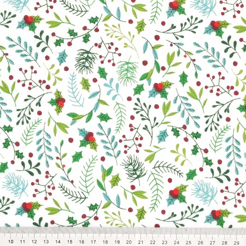 Festive holly leaves and berries printed on a white polycotton christmas fabric with a cm ruler