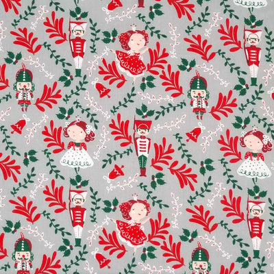 Nutcrackers and christmas fairies are printed on a silver polycotton fabric