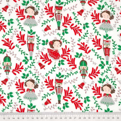 Nutcrackers and christmas fairies are printed on a white polycotton fabric with a cm ruler