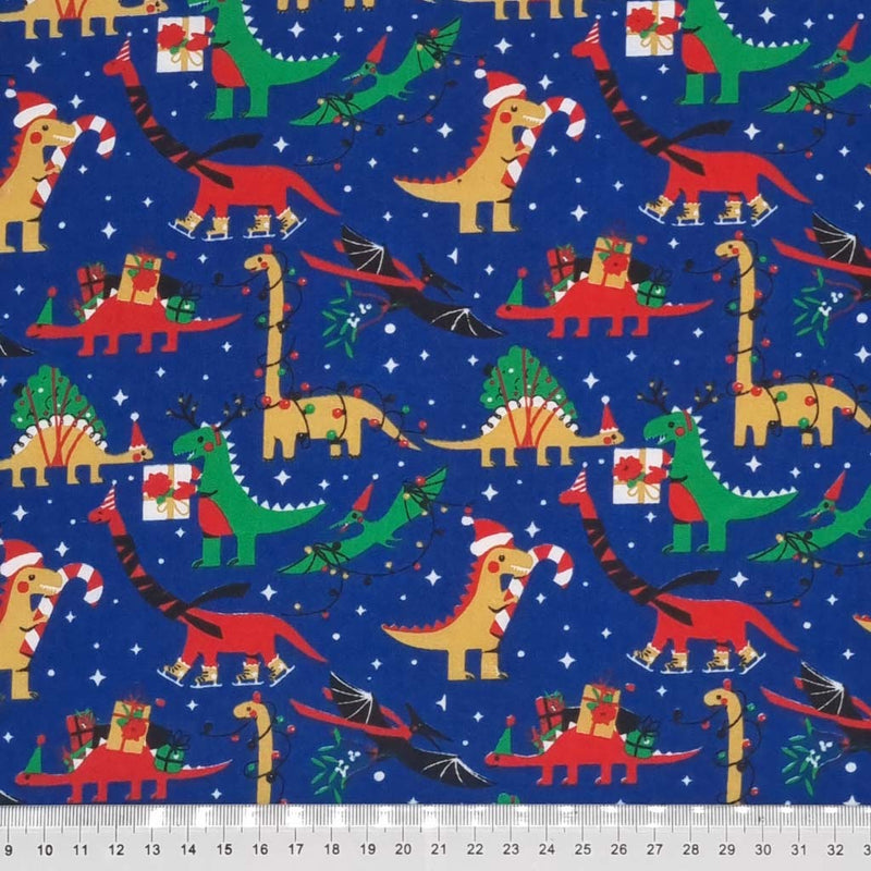 Festive dinosaur fabric print on blue polycotton with a cm ruler