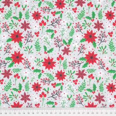 A christmas poinsettia fabric print on a silver polycotton with a cm ruler