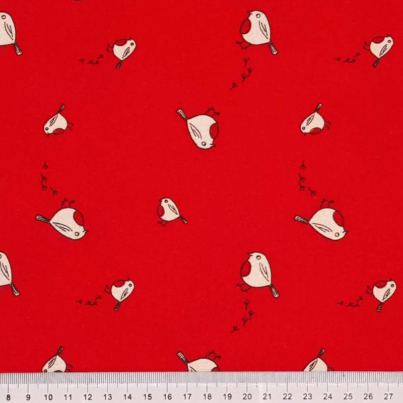 Christmas robins and their footprints on a red 100% cotton fabric with a cm ruler
