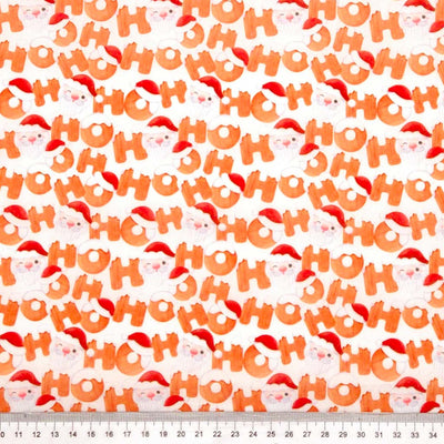 Ho Ho Ho and Santa faces printed on a white christmas polycotton fabric with a cm ruler