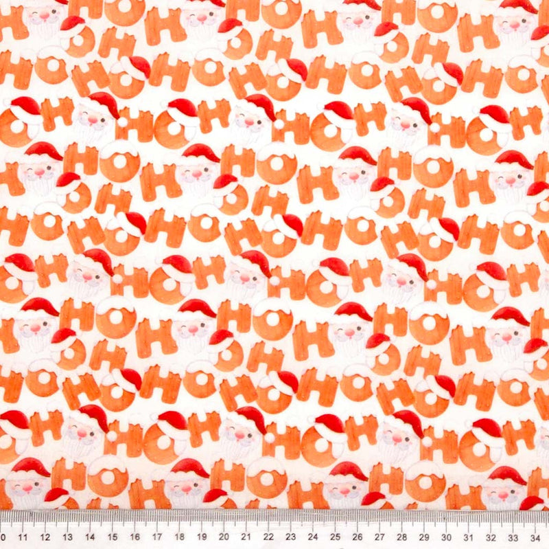 Ho Ho Ho and Santa faces printed on a white christmas polycotton fabric with a cm ruler