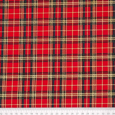 Red and green tartan with gold detail are printed on a cotton fabric