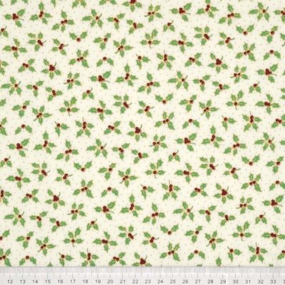 Green holly leaves are printed on an ivory cotton fabric