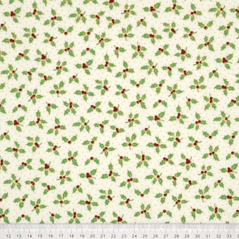 Green holly leaves are printed on an ivory cotton fabric