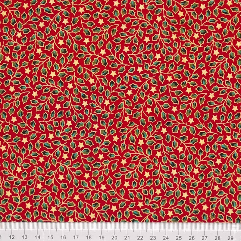 Green and gold mini holly leaves are printed on a red christmas cotton fabric