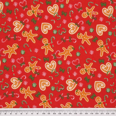 Gingerbread men and hearts printed on a red polycotton fabric