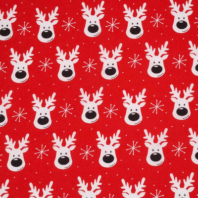 Smiling reindeer faces printed on a red polycotton fabric