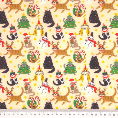 Christmas cats printed on a polycotton fabric with a cm ruler