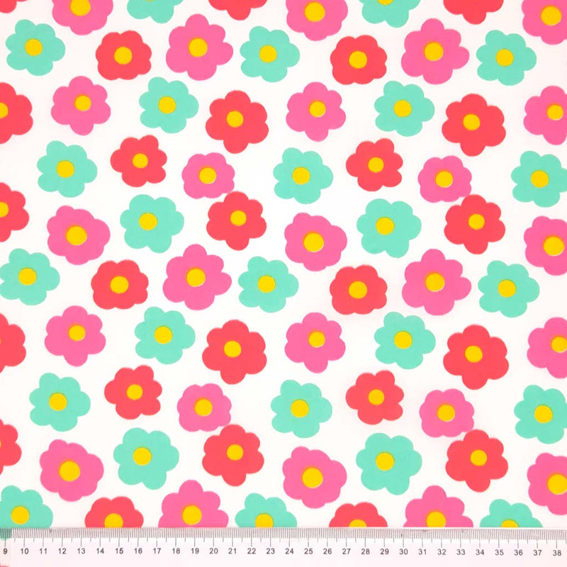 Pattern of colorful flowers on a white background with a ruler at the bottom.