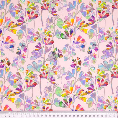 Colourful clover printed on a pink cotton fabric by Little Johnny with a cm ruler