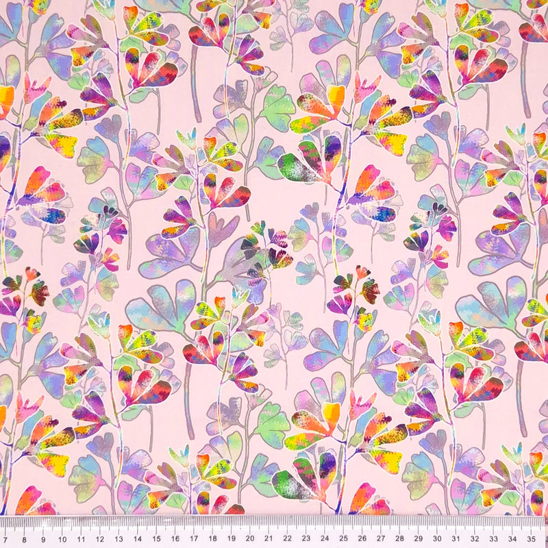 Colourful clover printed on a pink cotton fabric by Little Johnny with a cm ruler