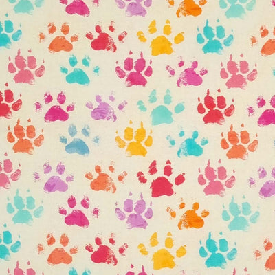 Colourful paw prints printed on a light beige cotton fabric