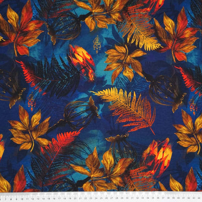 Golden and red leaves are printed on a navy blue viscose jersey fabric with a cm ruler