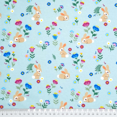 Baby bunnies printed on a jade cotton jersey fabric with a cm ruler