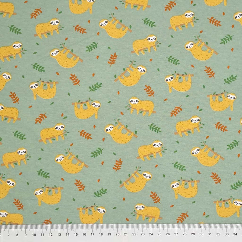 Sloths printed on a cotton jersey fabric with a cm ruler