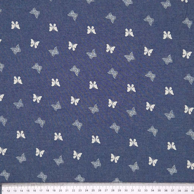 Mini butterflies printed on a cotton chambray fabric with a cm ruler