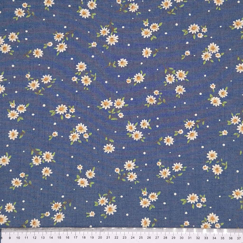 Ditsy daisies printed on a cotton denim chambray fabric with a cm ruler