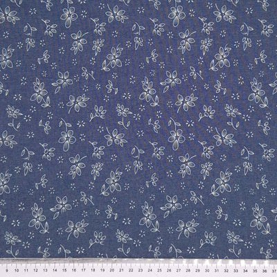 Ditsy flowers printed on a cotton denim chambray fabric with a cm ruler