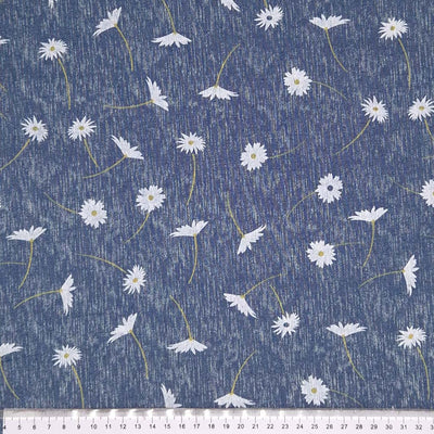 Daisies printed on a chambray fabric with a cm ruler