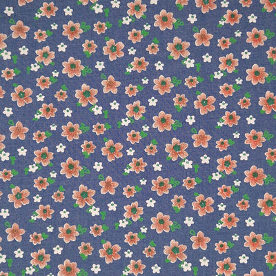 Peach coloured flowers printed on a medium blue cotton denim chambray fabric