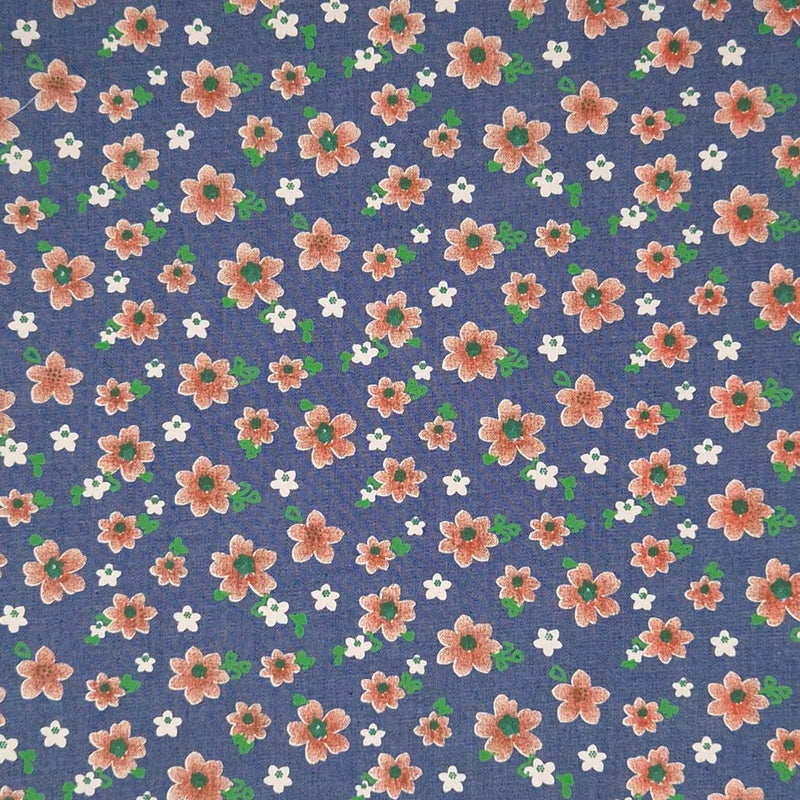 Peach coloured flowers printed on a medium blue cotton denim chambray fabric