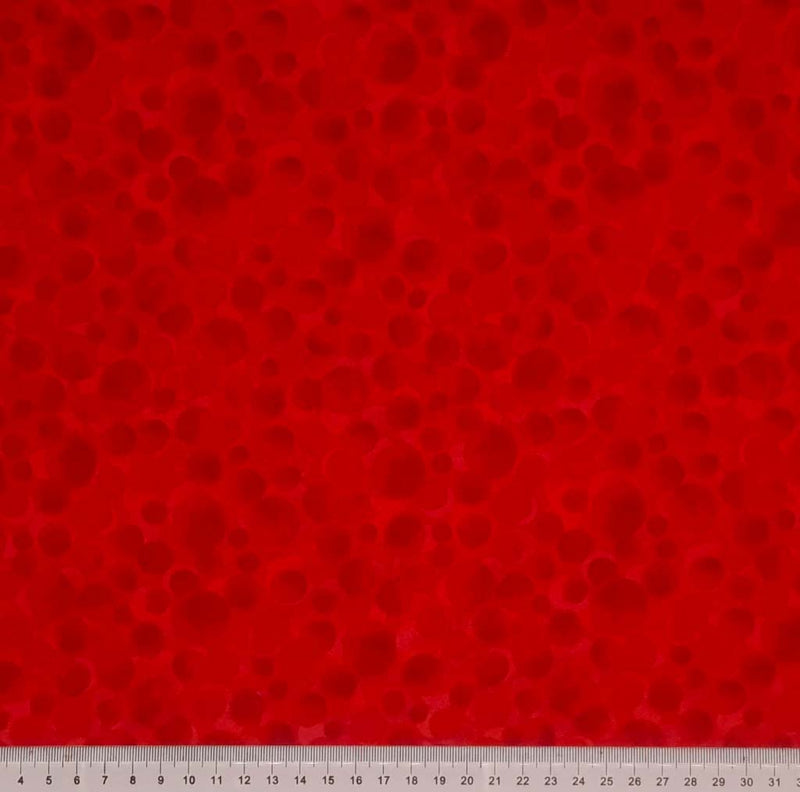 Multi-sized dots printed on a postbox red 100% cotton with a cm ruler