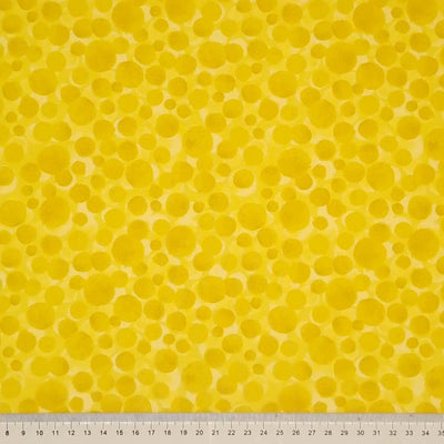 Multi-sized dots printed on a sunshine yellow 100% cotton with a cm ruler