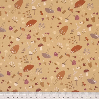 Scattered wild mushrooms and snails are printed on a light burnt orange 100% cotton by Lewis & Irene with a cm ruler