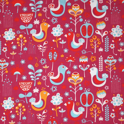 Blue scandinavian style birds are printed on a cerise pink cotton fabric
