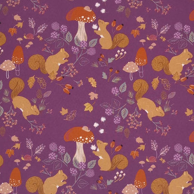 Squirrels and mushrooms are printed on a mulberry purple cotton quilting fabric by Lewis & Irene
