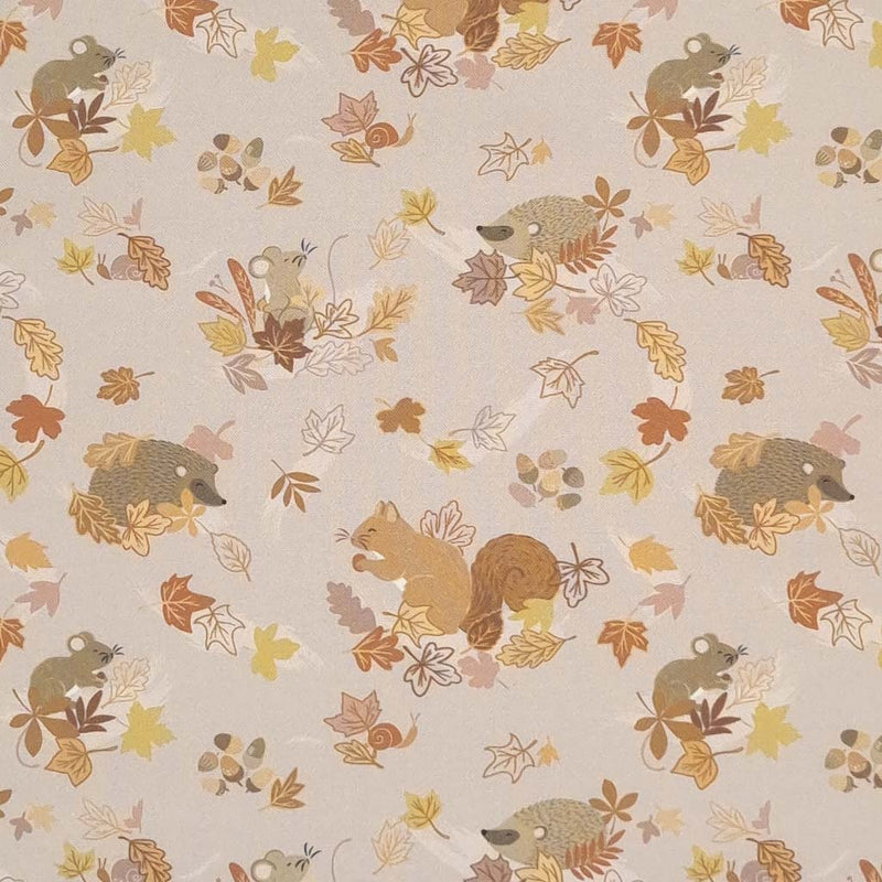 Beautiful squirrels, mice and hedgehogs can be found hiding in autumnal leaves on a light taupe 100% cotton. 
