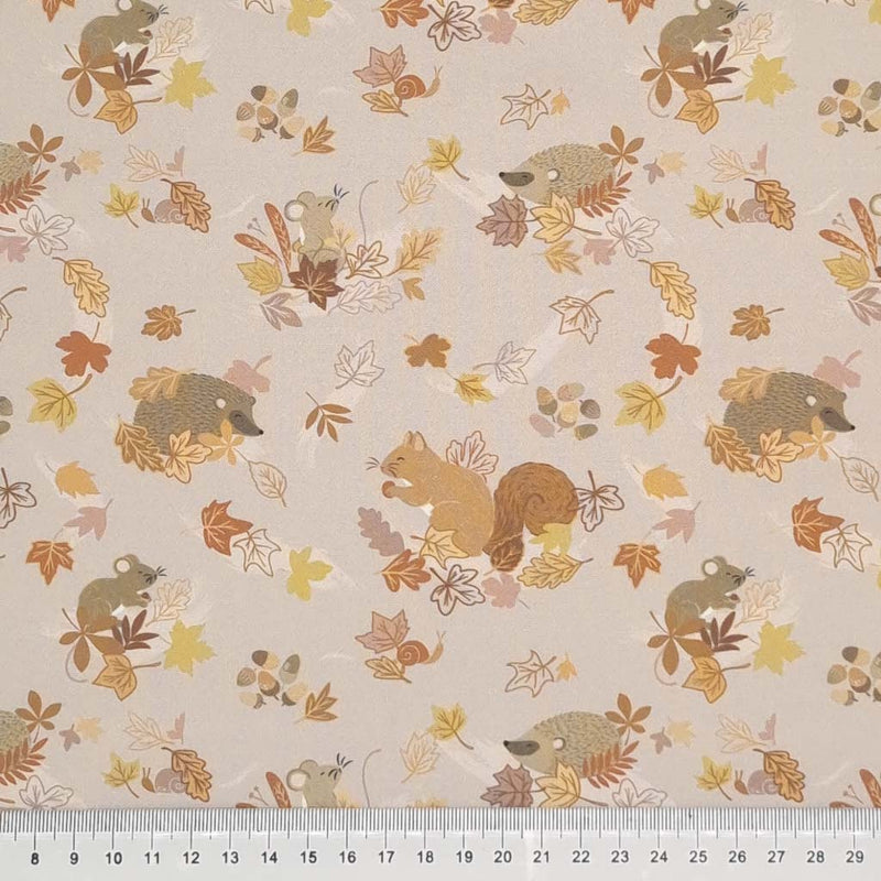 Beautiful squirrels, mice and hedgehogs can be found hiding in autumnal leaves on a light taupe 100% cotton. with a cm ruler