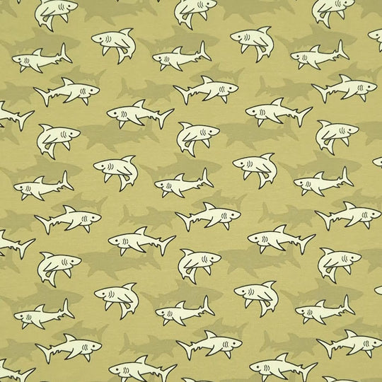 Swimming sharks are printed on a green cotton jersey fabric