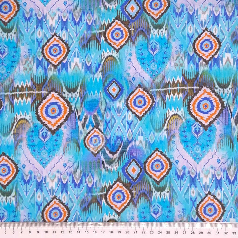 Aqua batik design printed on a cotton poplin for dressmaking with a cm ruler