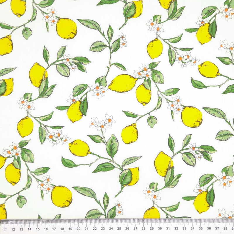 Lemons printed on an ivory cotton poplin fabric with a cm ruler