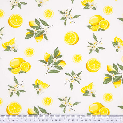 Lemons printed on an ivory coloured cotton poplin fabric with a cm ruler