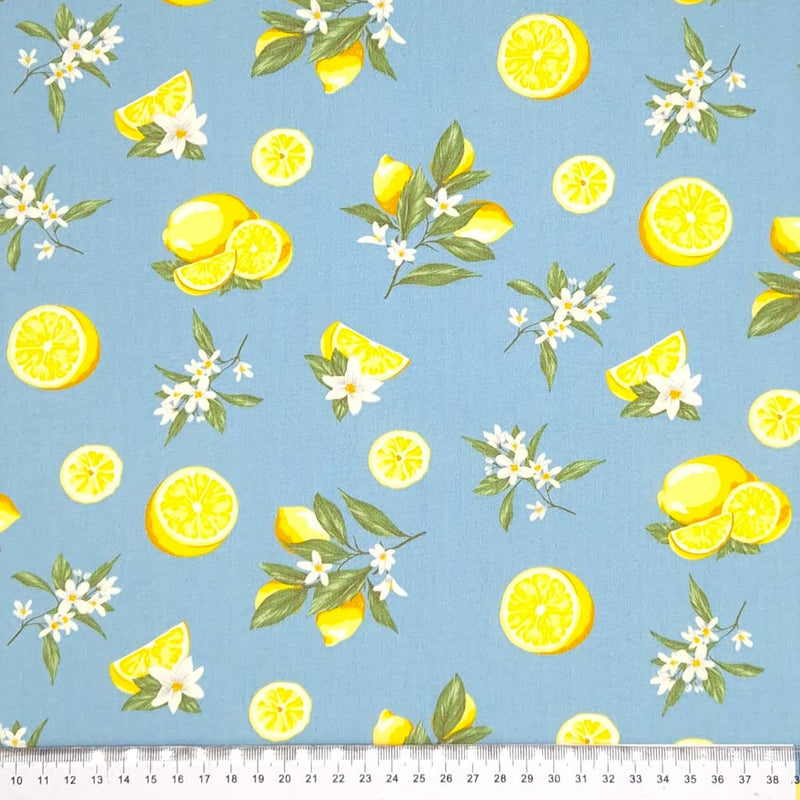 Lemons printed on a denim coloured cotton poplin fabric with a cm ruler